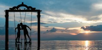 a couple standing in the sea while kissing
