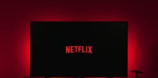a television with the netflix logo lit up in the dark