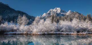 body of water near mountain during daytime