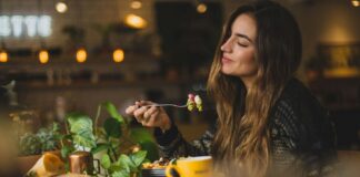 woman holding fork in front table