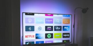 black flat screen tv turned on showing game