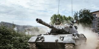 battle tank on green grass field during daytime