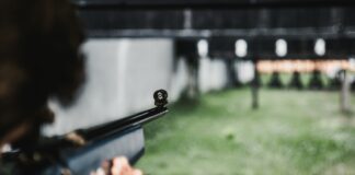 person aiming on the gun
