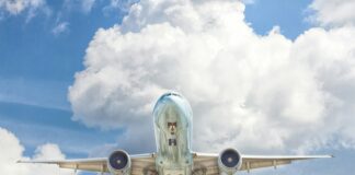 gray and white airplane on flight near clear blue sky
