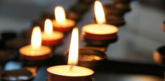 lighted candles on black metal candle holder