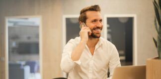 man using smartphone on chair