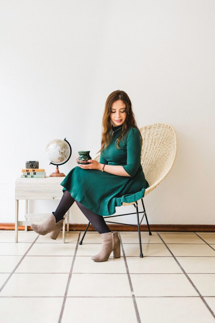woman in green dress sitting on chair