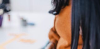 selective focus photography of woman holding phone