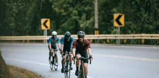 men riding bicycle on road during daytime