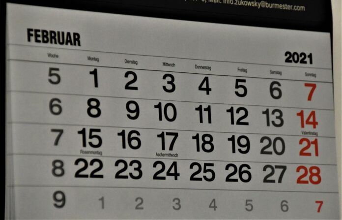 black and white calendar on white wall