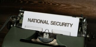 a close up of a typewriter with a national security sign on it