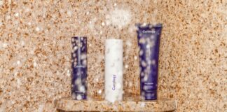 three assorted toiletries on brown shelf