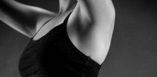 grayscale photo of person wearing sports bra and leggings
