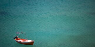 red boat on blue ocean during daytime