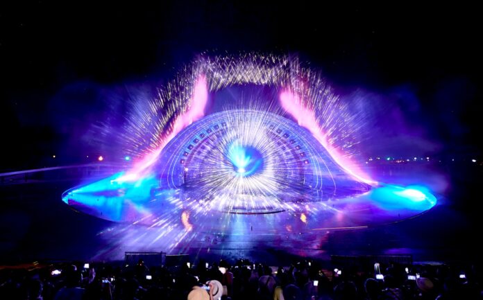 a crowd of people standing around a stage