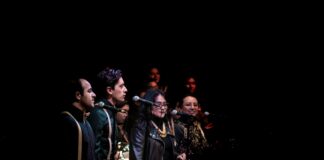 people standing on stage performing song
