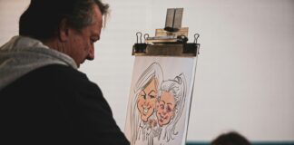 man painting two women