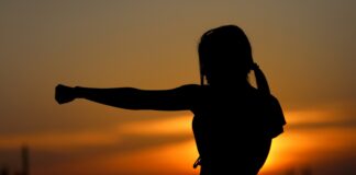 woman punching the air during golden hour