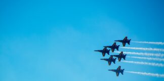 six black fighter jets doing air show during daytime