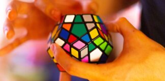 person holding 3 x 3 rubiks cube
