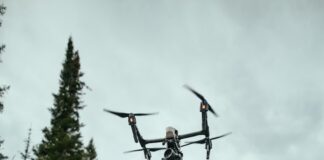 quadcopter drone flying in mid-air during daytime