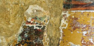 a painting of a person standing in front of a wall