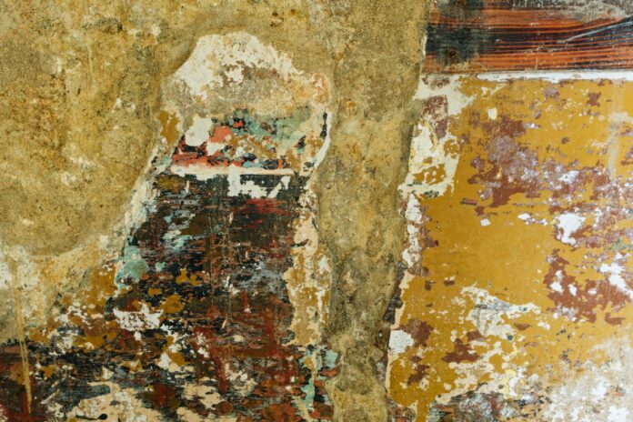 a painting of a person standing in front of a wall