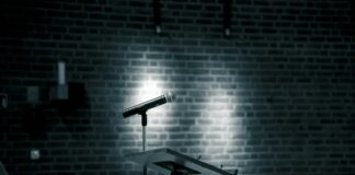 a microphone on a stand in front of a brick wall
