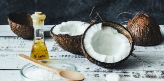 white powder in clear glass jar beside brown wooden spoon
