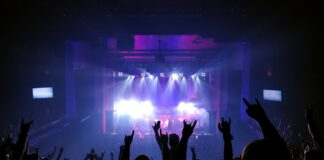 people standing on stage with lights