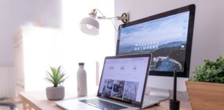 MacBook Pro on table beside white iMac and Magic Mouse
