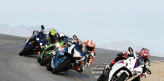 group of people riding sports motorcycles