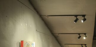 A long hallway with paintings on the wall