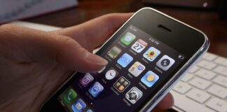 A person holding an iPhone in their hand