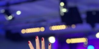a woman with her hand up in the air