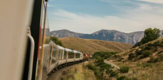 white train with the distance of mountain during daytime
