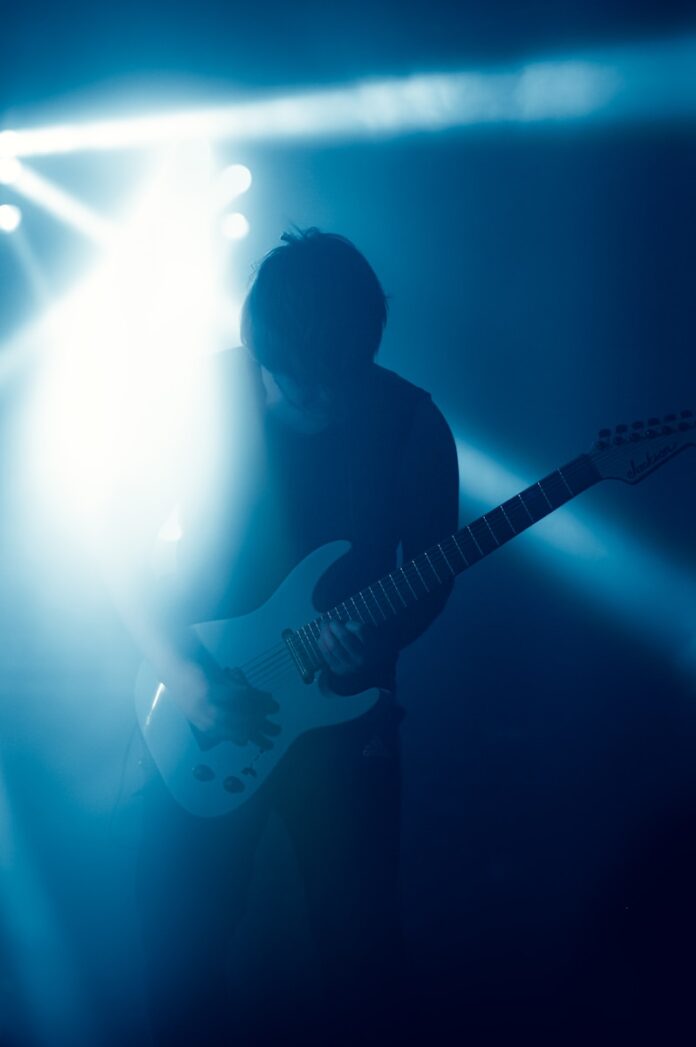 A man playing a guitar on a stage
