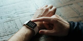 person touching Apple watch