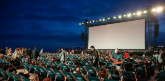 group of people sitting on raw gray chairs