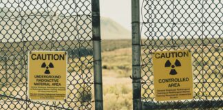 a couple of signs that are on a fence