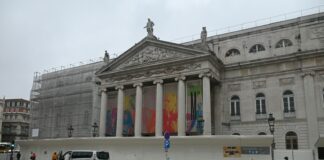 cars parked in front of a large building