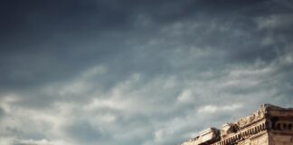 man and woman statue under blue sky during daytime