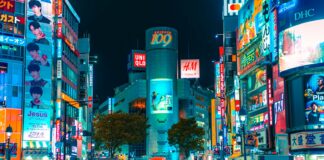 people gathered outside buildings and vehicles