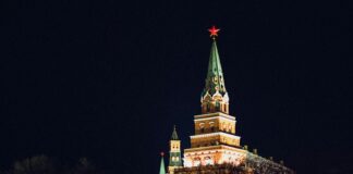 a large building with a steeple lit up at night