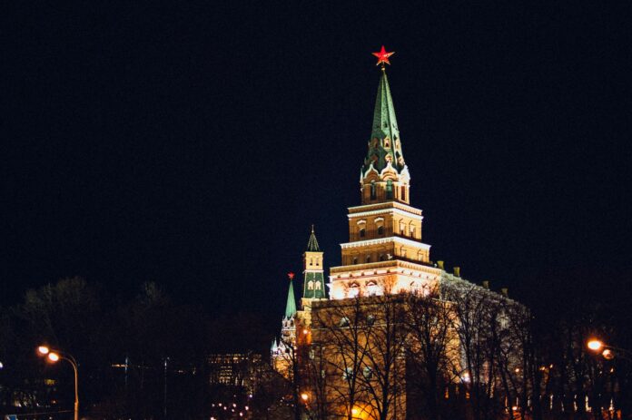 a large building with a steeple lit up at night