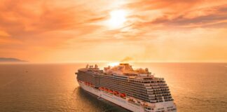 white ship on sea during sunset