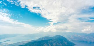 a body of water with mountains in the back