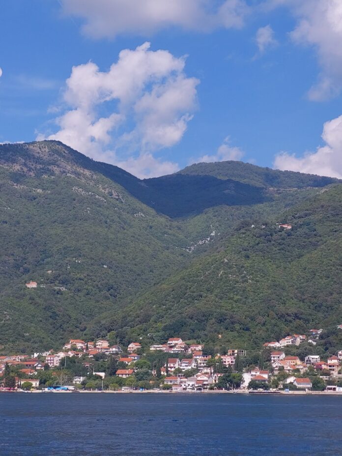a view of a small town on the shore of a lake