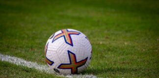 a soccer ball sitting on top of a soccer field