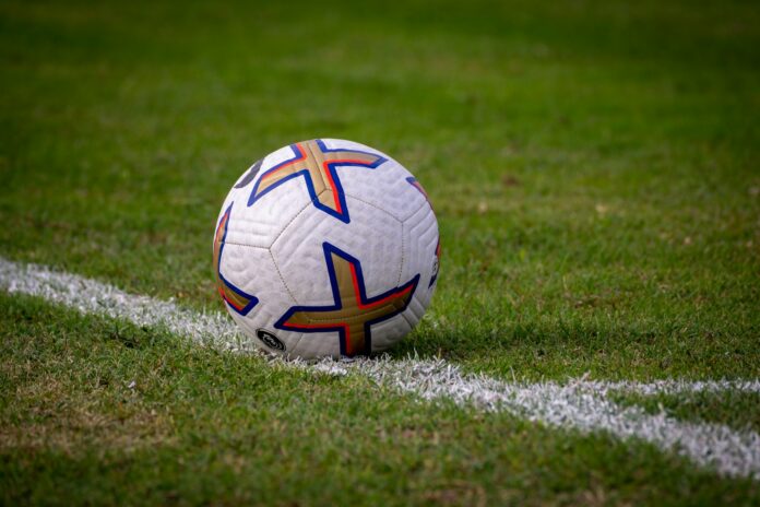 a soccer ball sitting on top of a soccer field